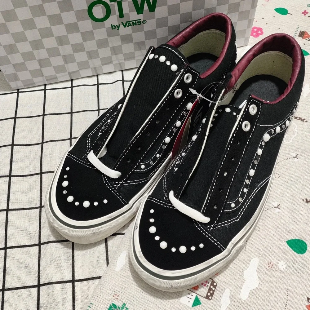 Vans Black Canvas Slip-On Sneakers with Maroon Lining and White Stud Detail